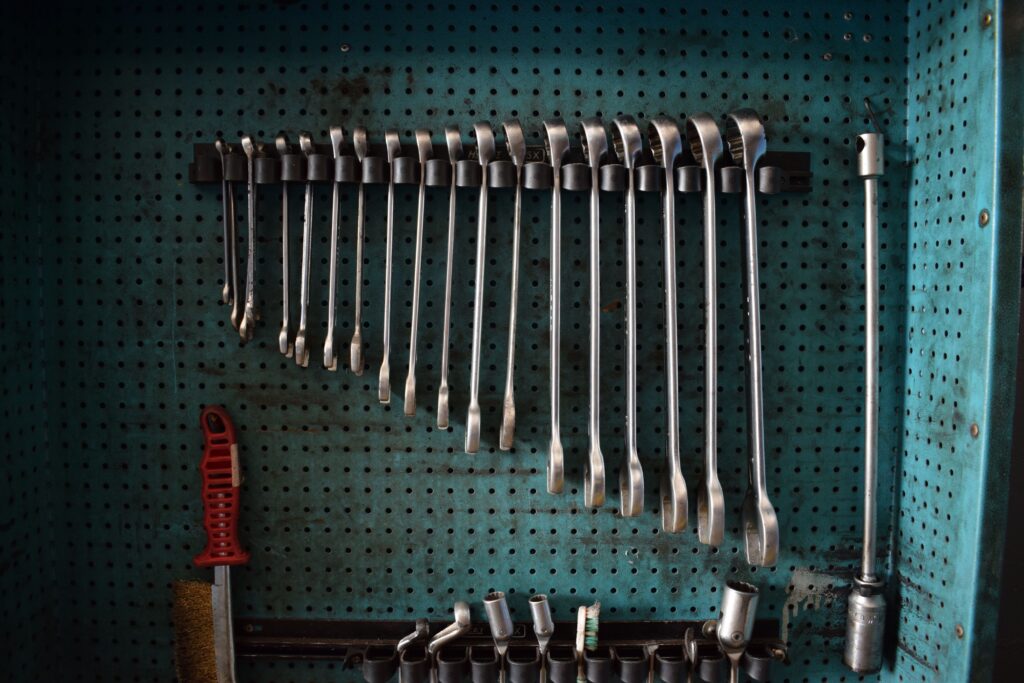A rack of interchangeable spanners on a workshop pegboard